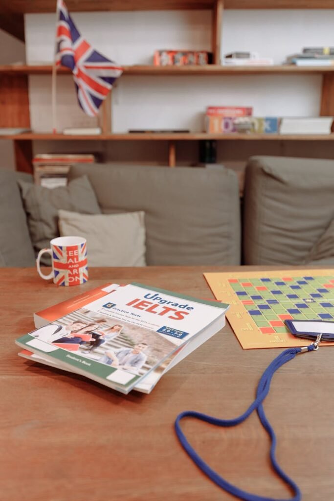 IELTS prep materials on a coffee table with a British flag mug and decor. Ideal for education themes.