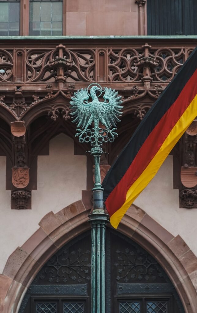 a flag on a pole in front of a building