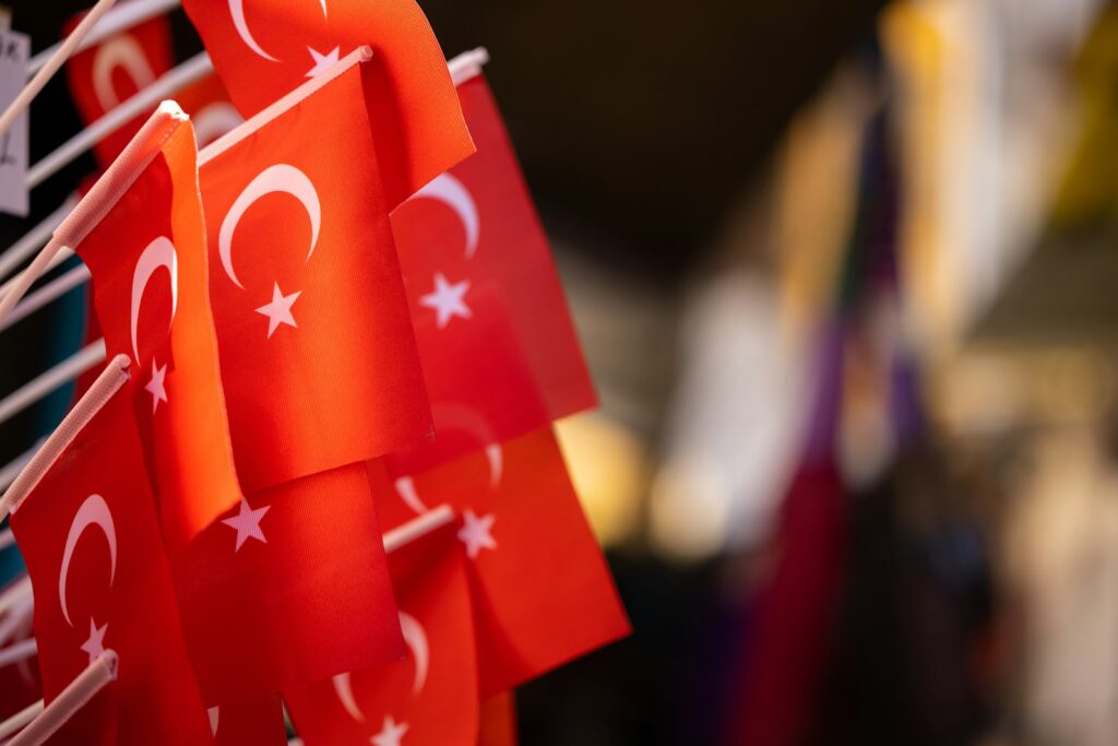 a row of red flags with white stars and crescents