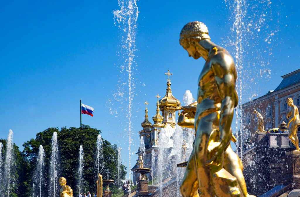 gold statue of man with flags on top